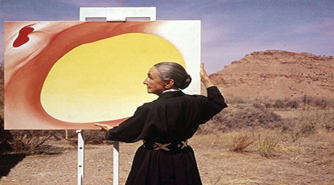 Georgia O'Keeffe adjusts a canvas from her Pelvis Series- Red With Yellow in Albuquerque, New Mexico
